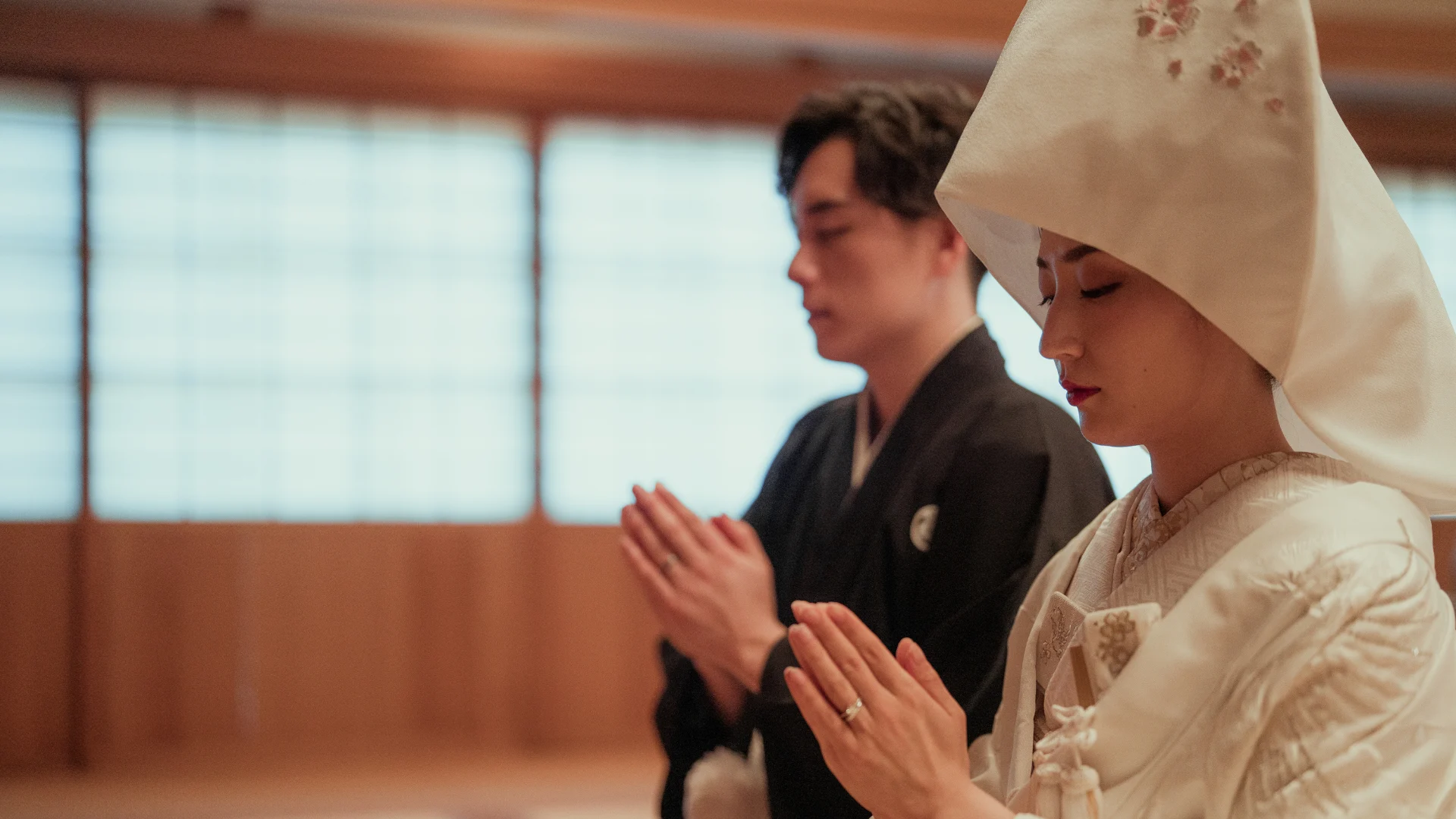 A priest performs a purification ritual to cleanse the couple and attendees, preparing them for the sacred vows ahead.