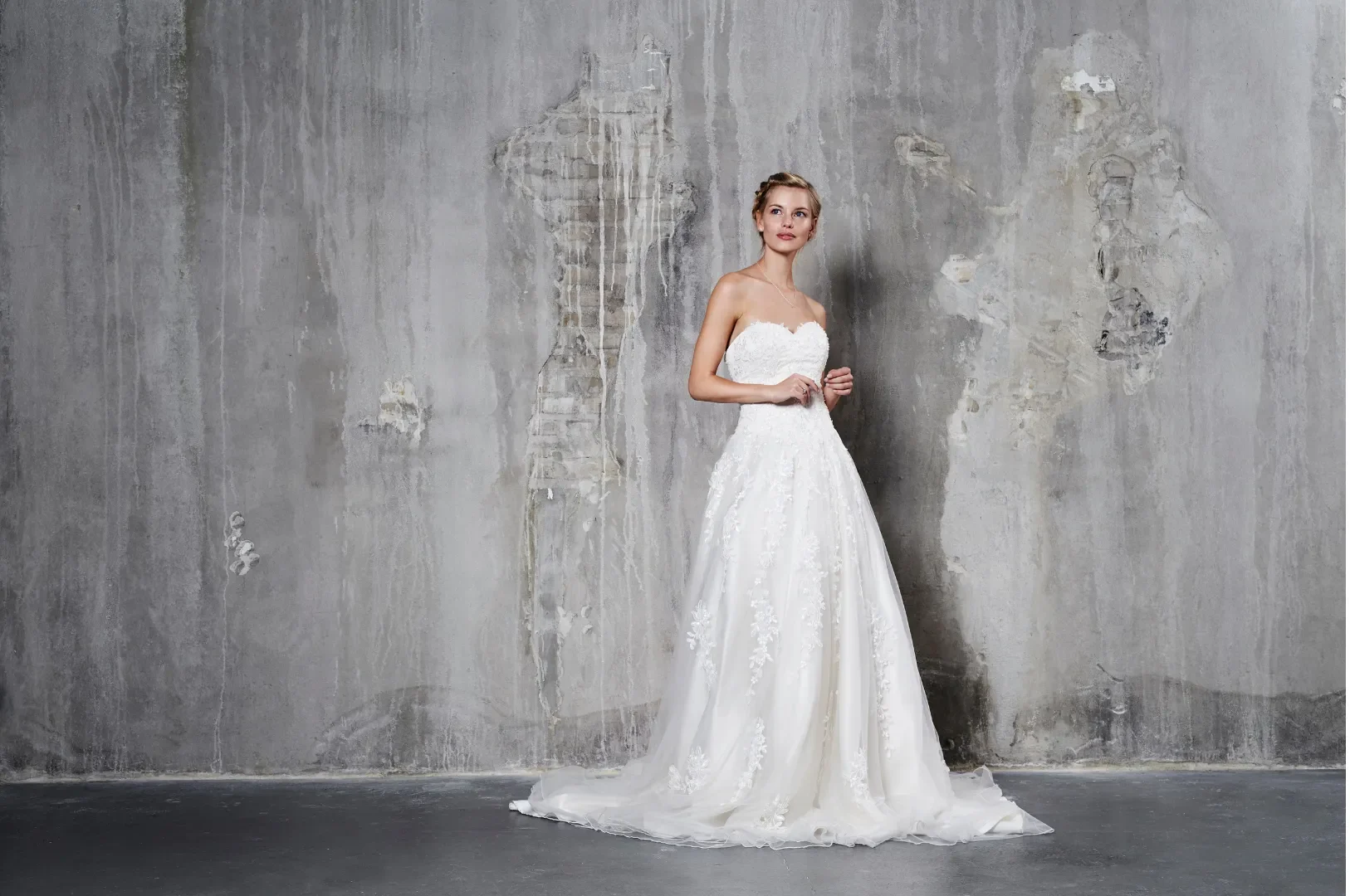 A modern wedding dress with a sleek silhouette and delicate lace detailing, perfect for contemporary and versatile ceremonies.