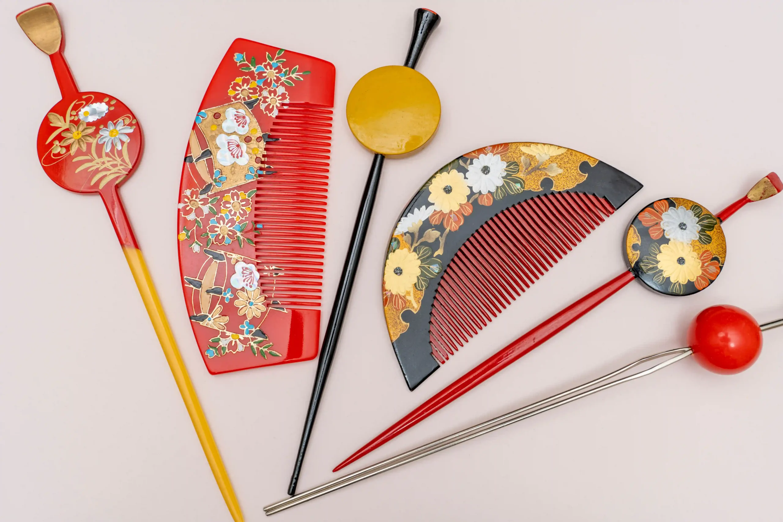 Traditional Japanese bridal hair accessories, including vibrant kanzashi hairpins and decorative combs adorned with floral motifs, used to complement wedding hairstyles.