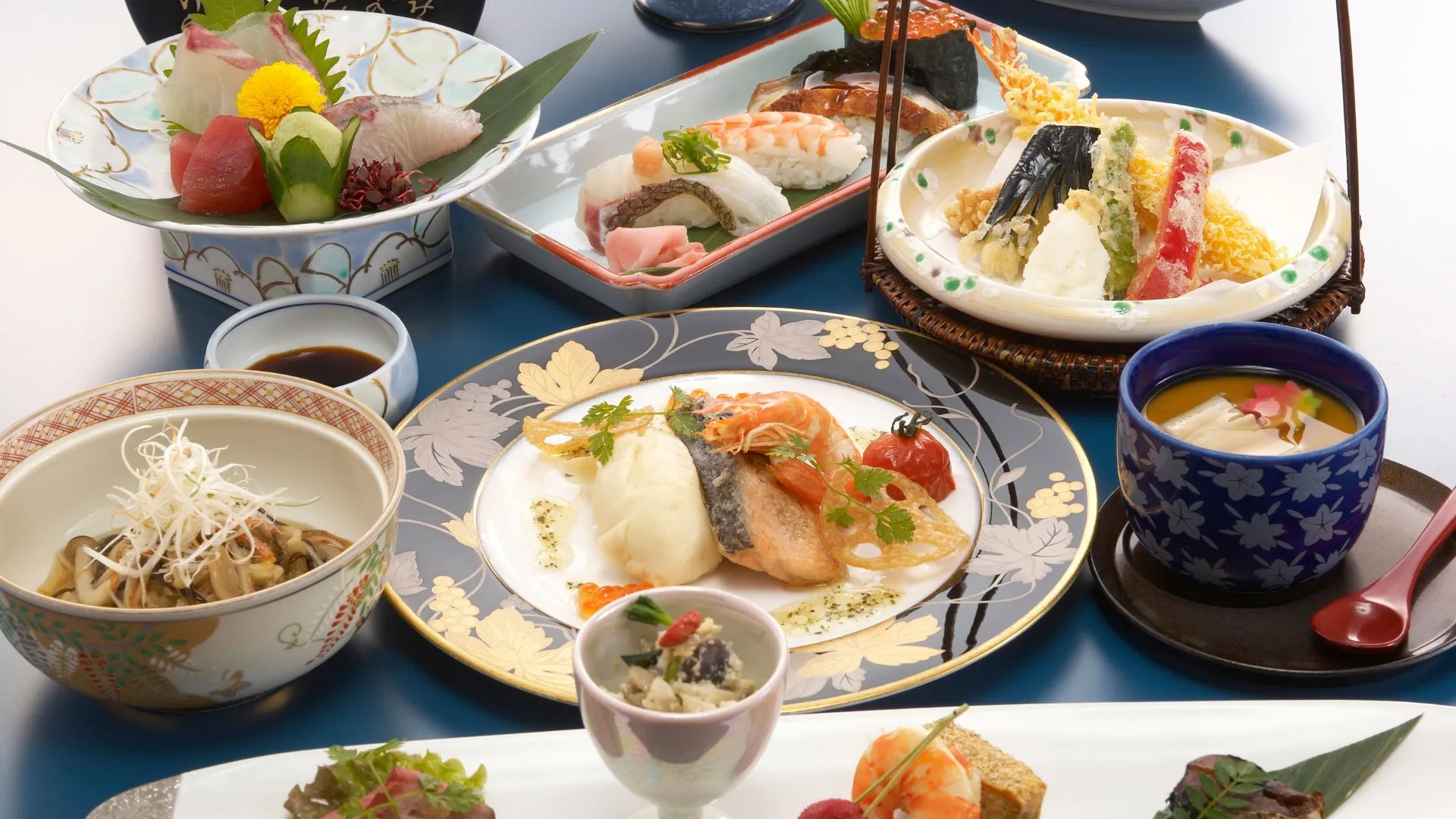 Elegant multi-course Kaiseki meal served at a Japanese wedding reception, featuring sashimi, tempura, grilled fish, and traditional Japanese tableware