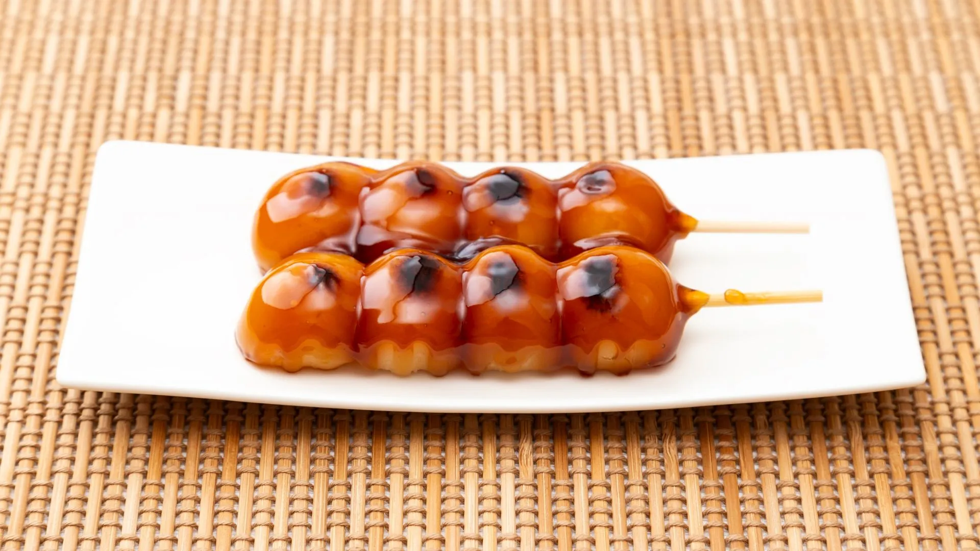 Mitarashi Dango (みたらし団子) – grilled rice dumplings coated in sweet soy glaze, served as a Japanese wedding dessert